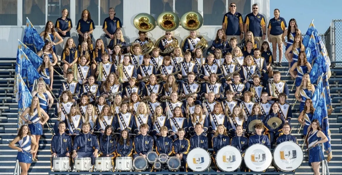 The 2026 United Local Marching Band, color guard and staff in the stands
